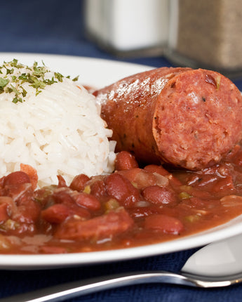 Plate of sausage, rice, and baked beans