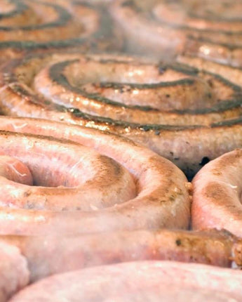 Cooking sausages on the grill with smoke